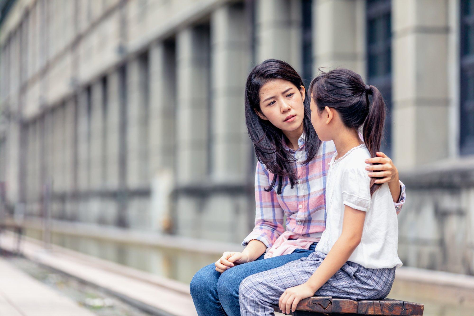 A mother having a serious talk with her daughter