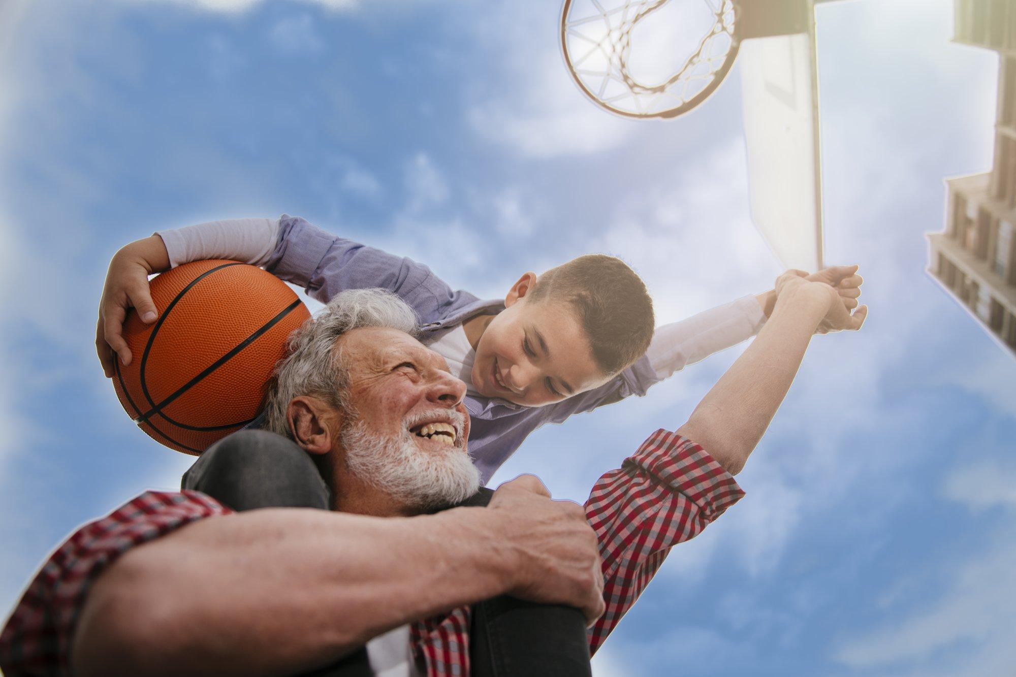 Grandfather And Grandson Playing Basketball