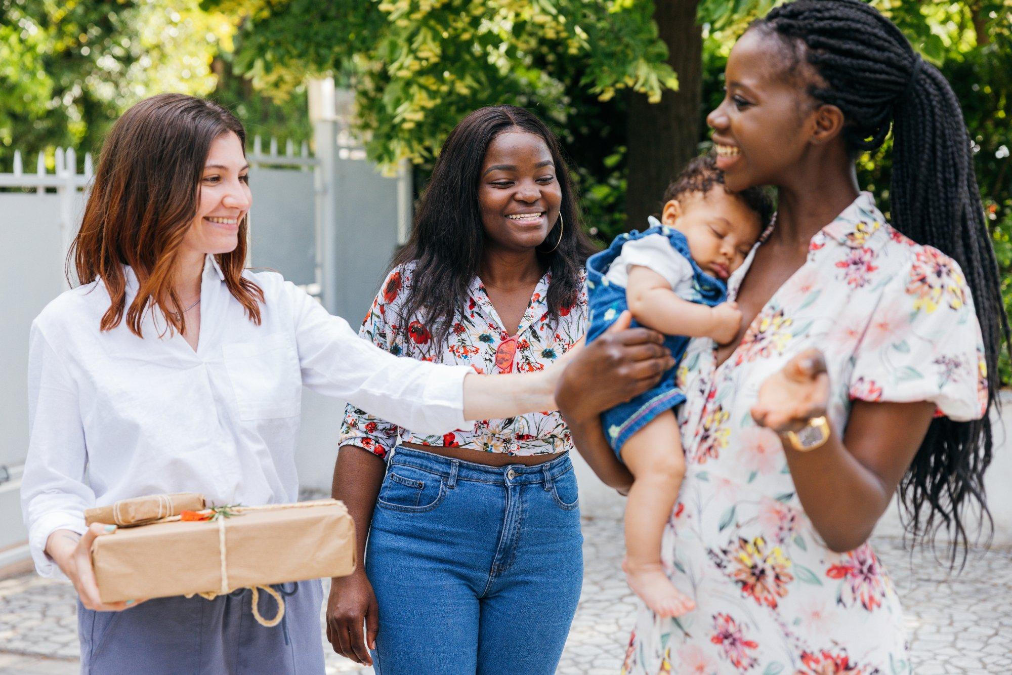 Group of three women celebrating newborn baby