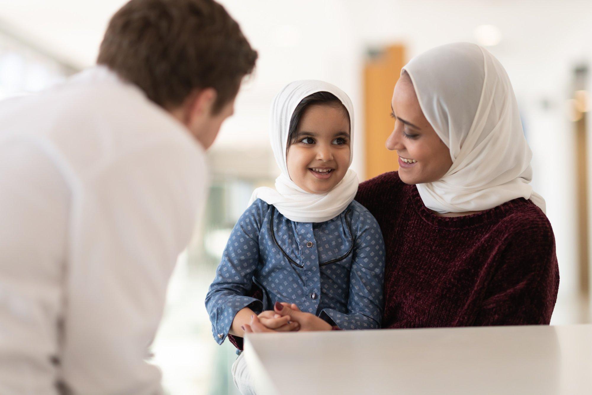 Male doctor comforts a young patient