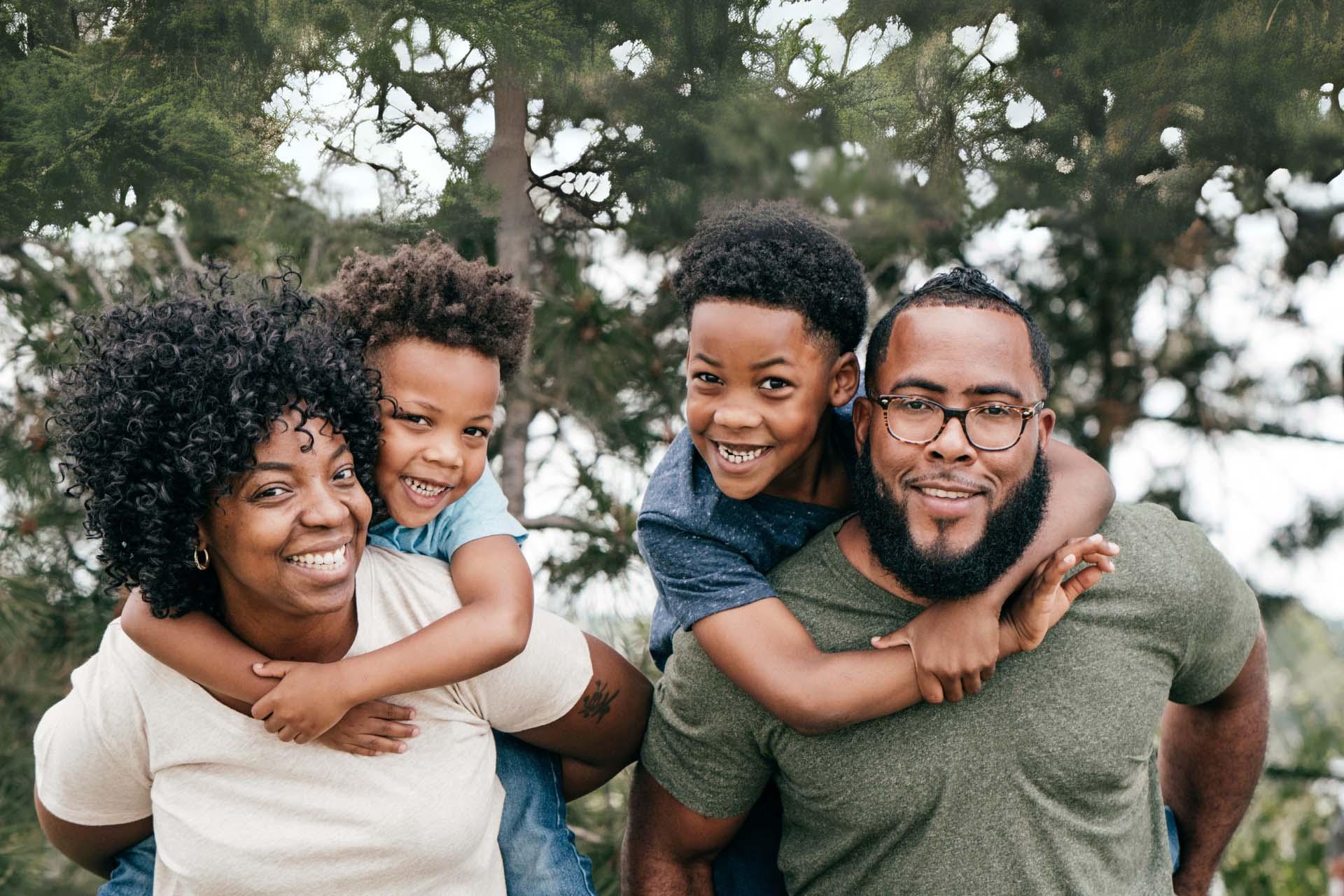 A famly of four smiling for a photo