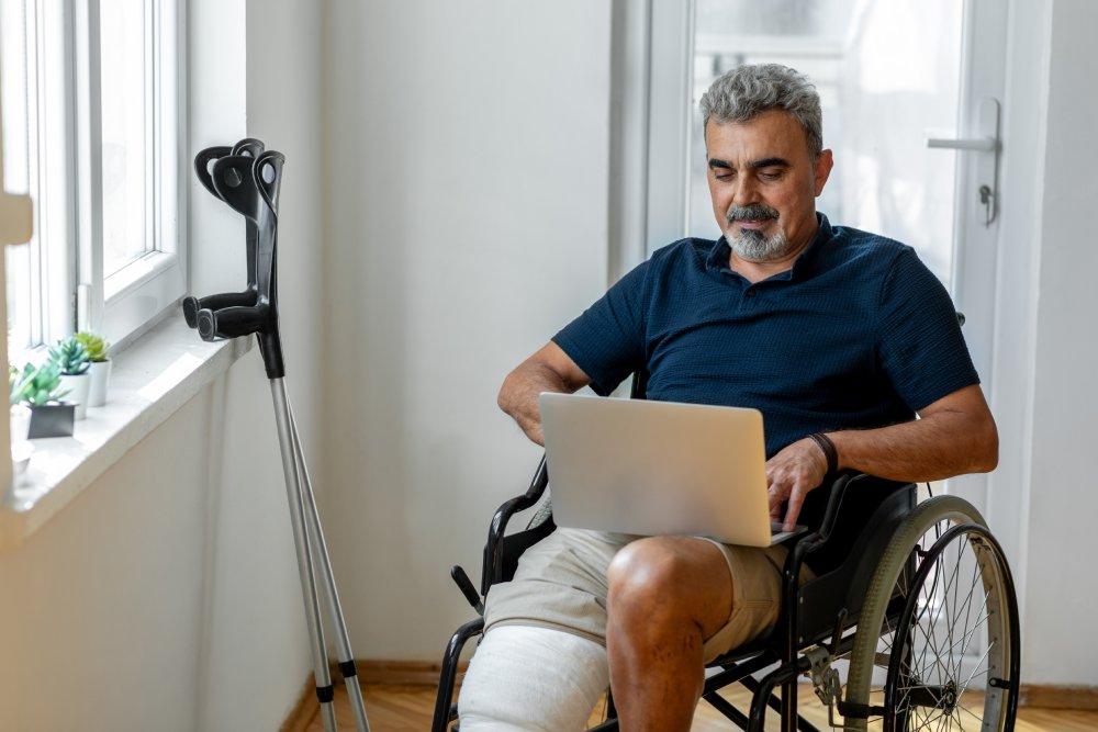 Senior man with broken leg on wheelchair