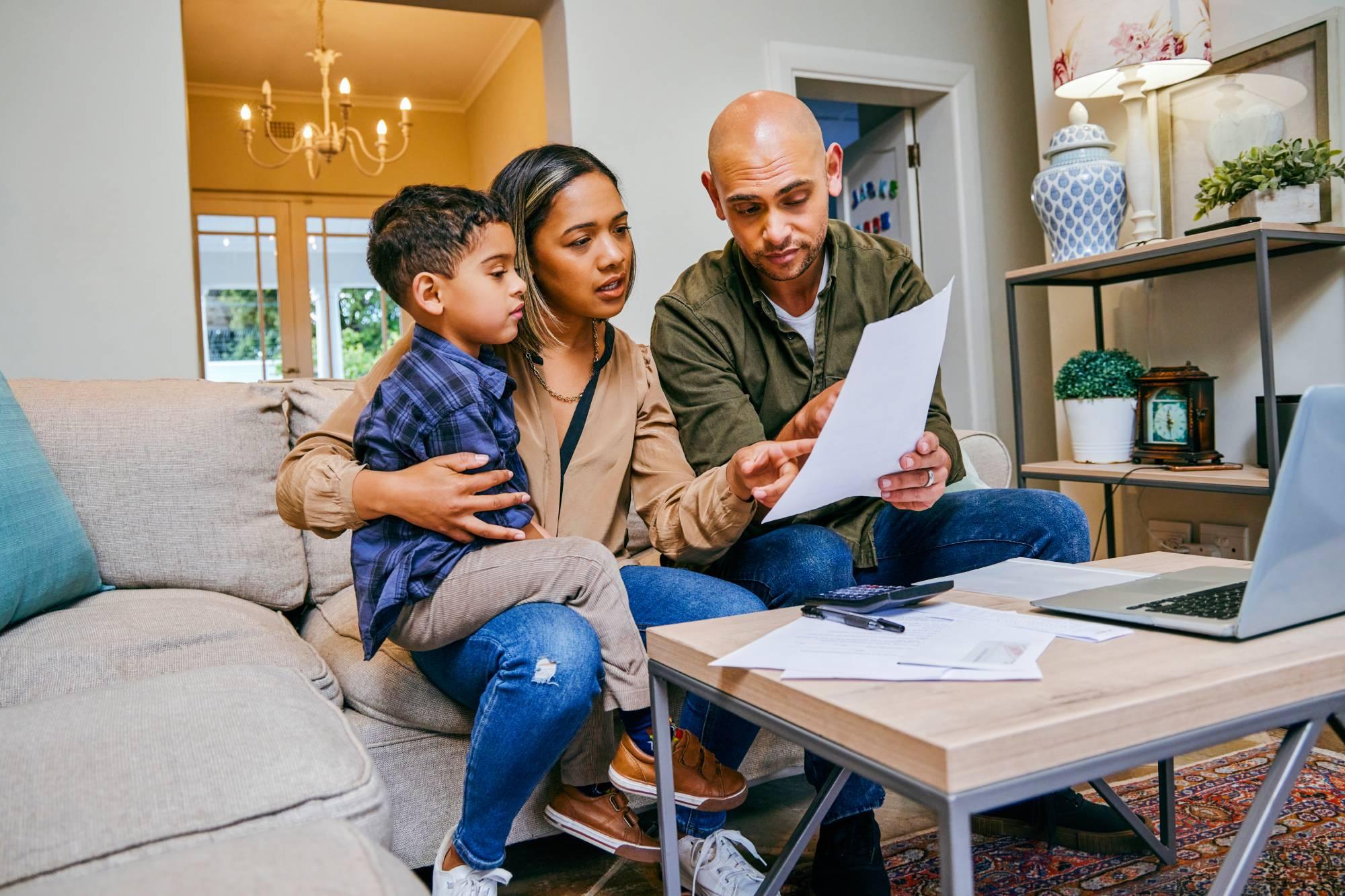 Shot of a young couple reviewing their finances while using their laptop