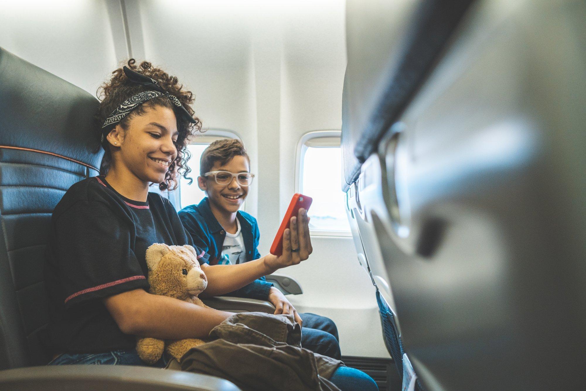 Siblings watching video during flight