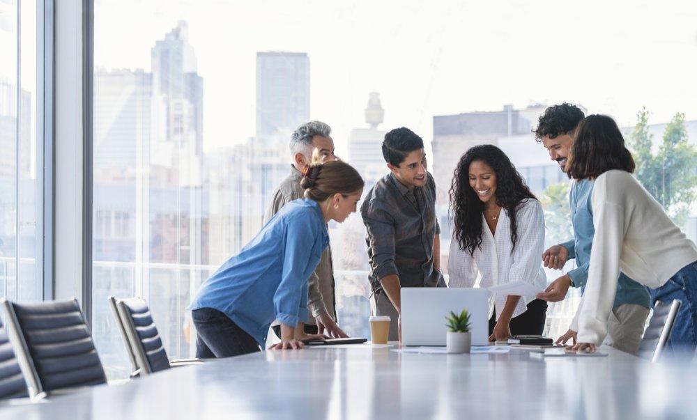 Team of business people working together in a board room